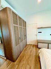 Bedroom with large wardrobe and wooden floor