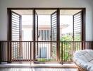 Balcony with wooden railing and open windows