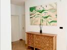 modern hallway with wooden cabinet and botanical wall art