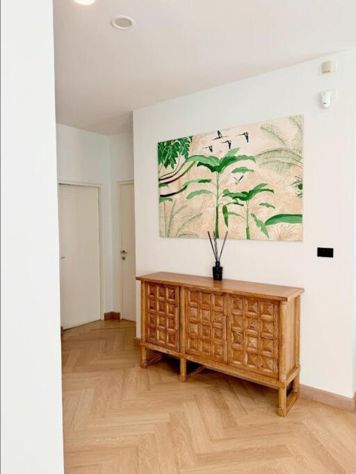 modern hallway with wooden cabinet and botanical wall art