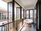 Well-lit balcony with large windows and a cozy chair