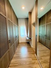 Spacious walk-in closet with wooden cabinetry