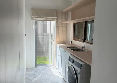 Modern laundry room with washer and storage