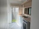 Modern laundry room with washer and storage