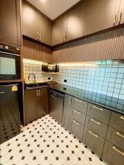 Modern kitchen with black and white tiled backsplash