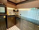 Modern kitchen with black and white tiled backsplash