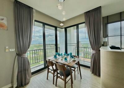 Modern dining area with large windows and balcony view