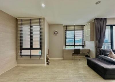 Modern living room with large windows and a black sofa