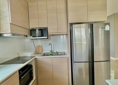 Modern kitchen with wooden cabinets and stainless steel appliances