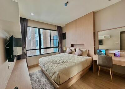 Spacious bedroom with large bed and desk