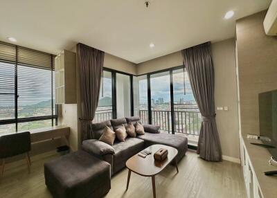 Modern living room with large windows and city view