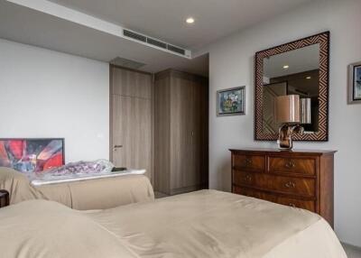 Modern bedroom with neutral tones and wooden furniture