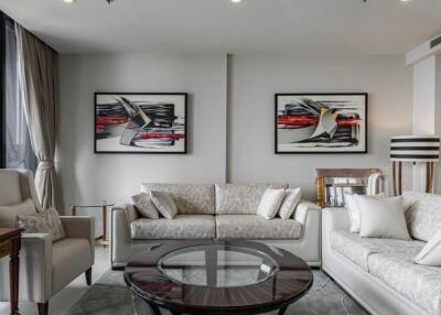 Modern living room with white sofas and contemporary artwork