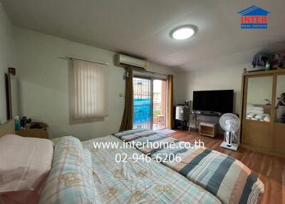 Spacious bedroom with a balcony featuring modern amenities