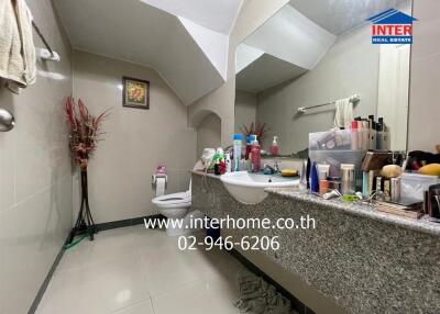 Bathroom with a large mirror and granite countertop