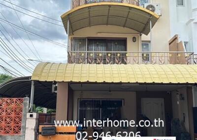 Front view of a three-story residential building with a signboard by the real estate agency Interhome.