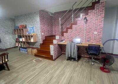 Living room with workstation and staircase