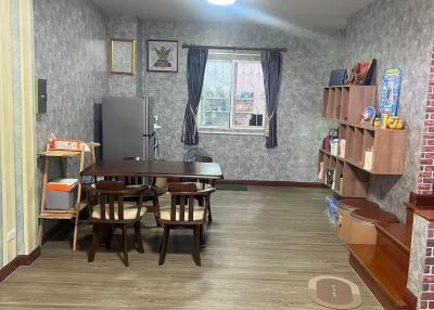 Dining area with wooden furniture and wall-mounted shelves