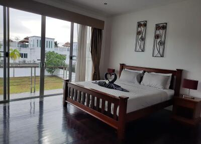 Spacious bedroom with large windows and balcony access