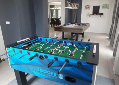 Game room with foosball and pool tables