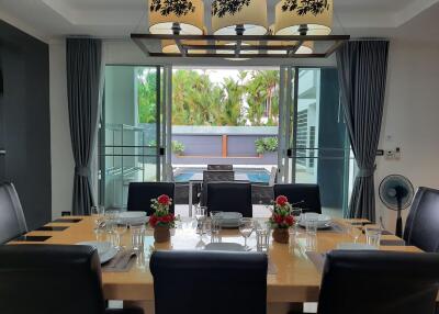 Dining area with table setting and view of pool