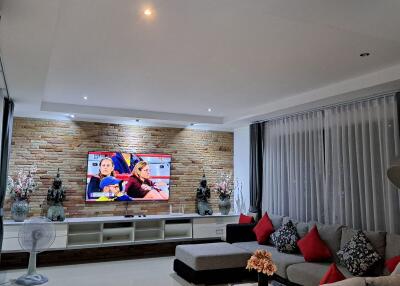 Modern living room with TV, L-shaped couch, and decorative elements