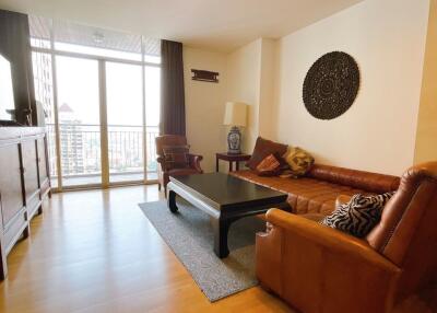 Spacious living room with large window and balcony access