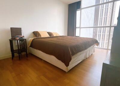 Well-lit bedroom with double bed and large window