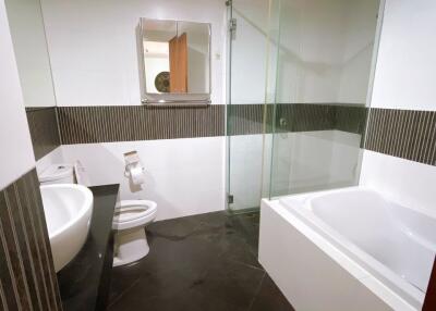 Modern bathroom with toilet, sink, and bathtub