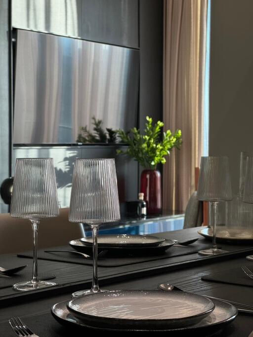 Elegantly set dining table with glasses and plates