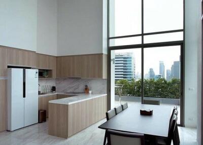 Modern kitchen with dining area and tall windows