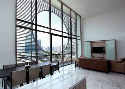 Spacious living room with large windows and city view