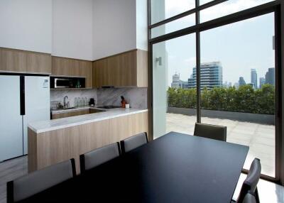 Modern kitchen and dining area with large windows and city view