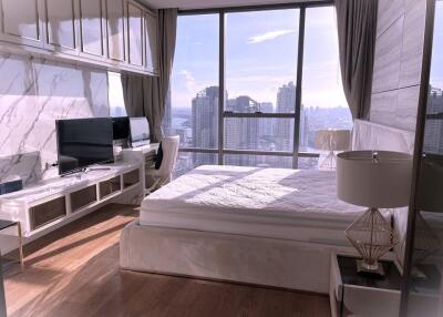 Modern bedroom with large windows and city view