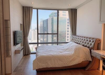 Bright and modern bedroom with a large window and city view