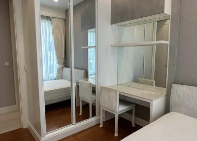 Bedroom with mirrored closet and desk