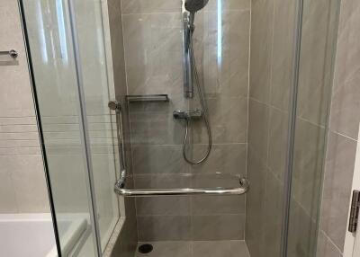 Modern bathroom with tiled shower and glass enclosure