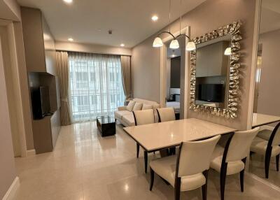 Modern living room with dining area and large mirror