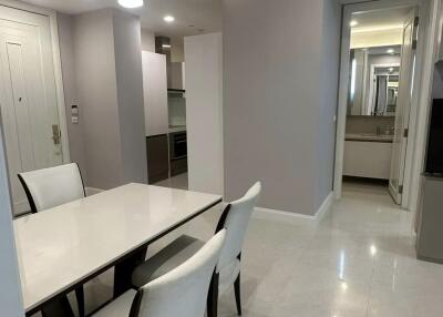 Modern dining area with white marble floor and beige walls