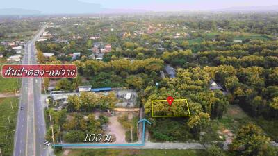 Aerial view of a land plot with surrounding area.