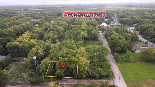 Aerial view of a plot of land surrounded by lush greenery