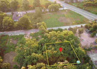 Aerial view of a plot of land with surrounding trees and roads