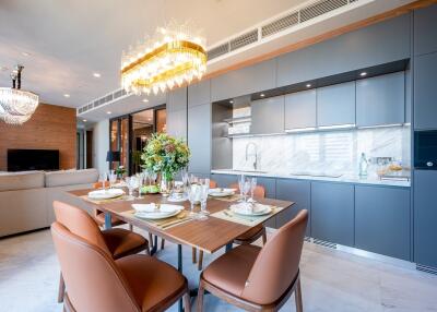 Modern kitchen and dining area with chandelier lighting