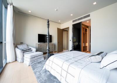 Modern bedroom with large windows and a four-poster bed