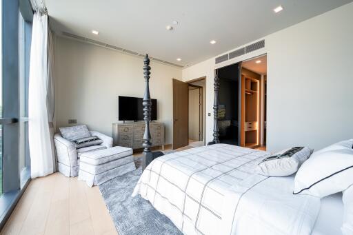 Modern bedroom with large windows and a four-poster bed