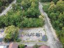 Aerial view of an empty land plot surrounded by trees.