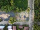 Aerial view of a plot of empty land surrounded by greenery