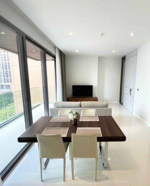 Modern living and dining area with large windows