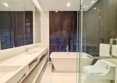 Modern bathroom with bathtub and glass-enclosed shower