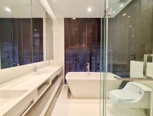 Modern bathroom with bathtub and glass-enclosed shower